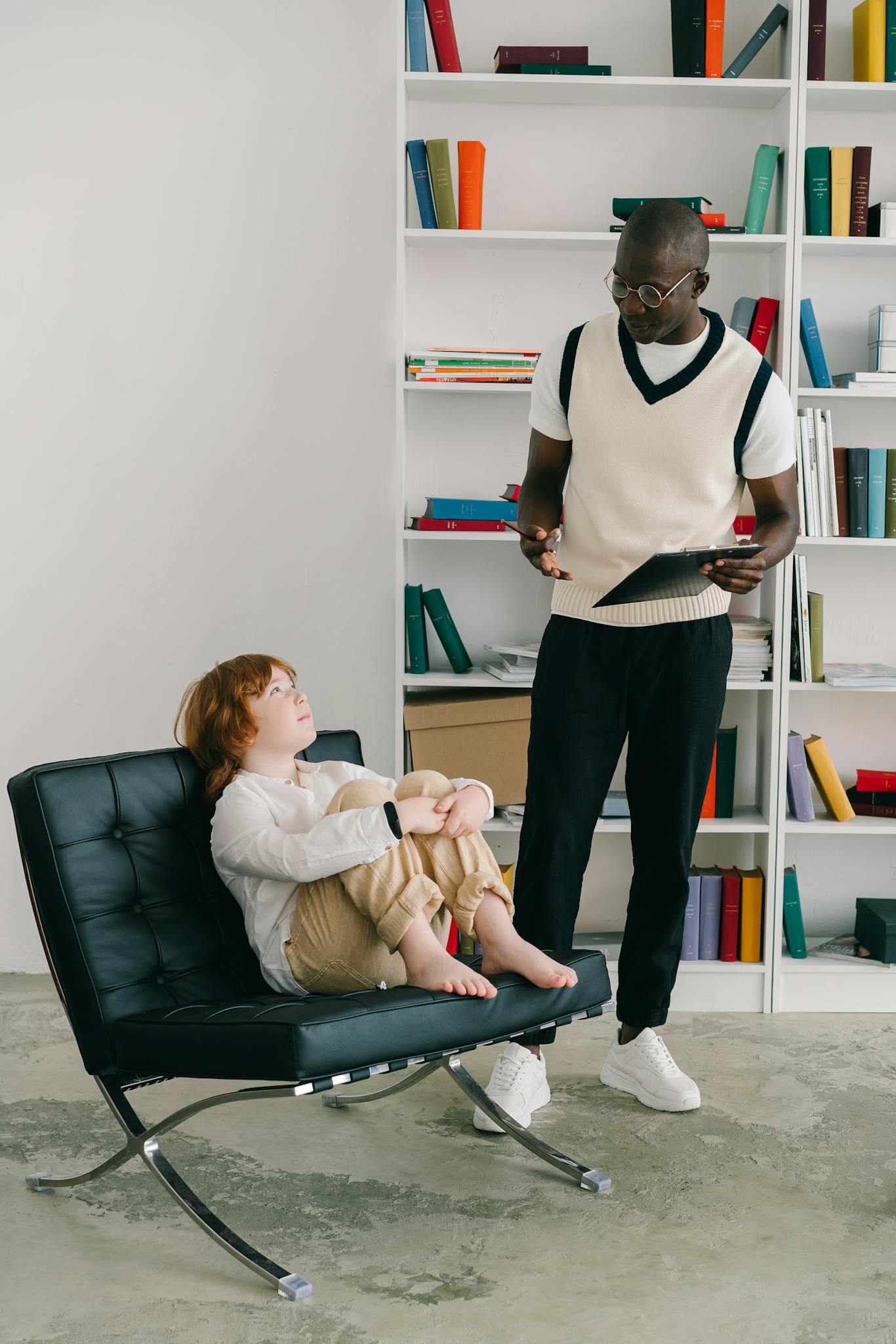 A child and therapist in a modern office during a psychotherapy session, emphasizing education and development.